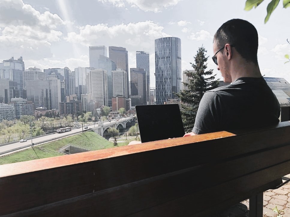 Man on the background of the city behind a laptop