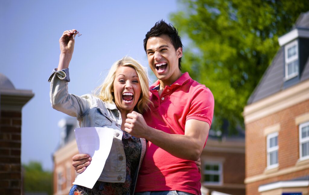 Young couple happy about buying a house